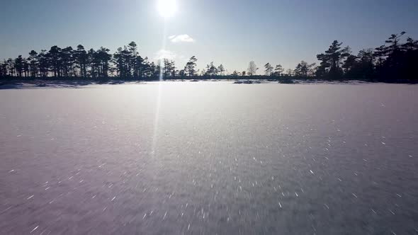 Aerial view of snowy bog landscape with frozen lakes in sunny winter day, Dunika peat bog (Rucava, L