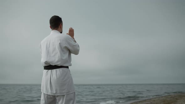 Unknown Karate Fighter Practicing Attacks in Overcast Weather By Day