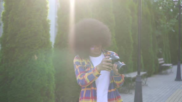 Portrait African Woman with an Afro Hairstyle Photographer with a Camera on the Urban Landscape
