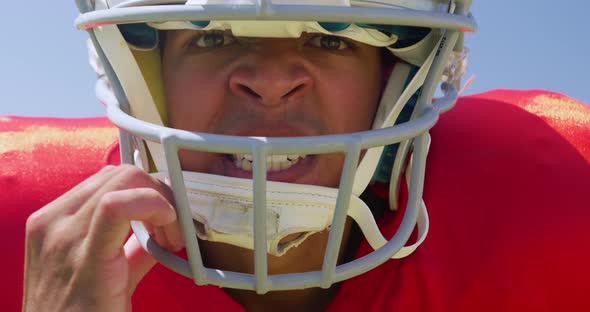 American football player standing with helmet