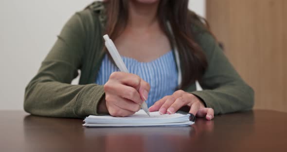 Woman write on note book at home