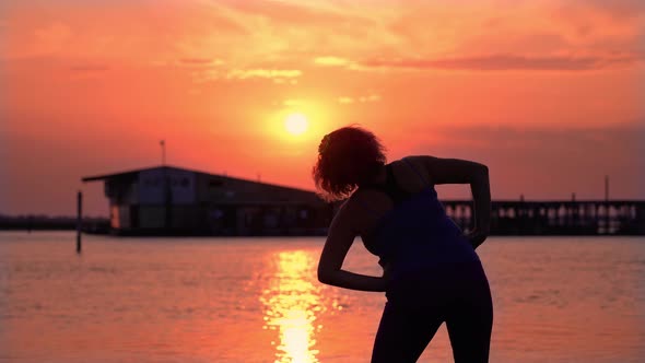 Plump Woman Does Sports Exercises on Empty Beach at Sunset