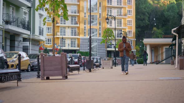 Happy Man Walking City Street Using Smartphone