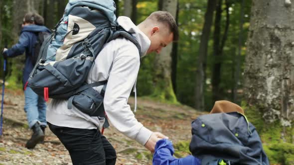 Boy Helps Girl As Hiking