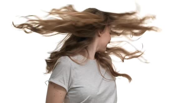 Portrait of Fascinating Woman 20s with Blue Eyes Having Fun and Shaking Her Head with Dark Curly