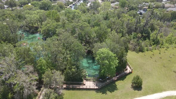 Three sisters spring near Crystal River, Florida. Kayakers and swimmers, aerial view