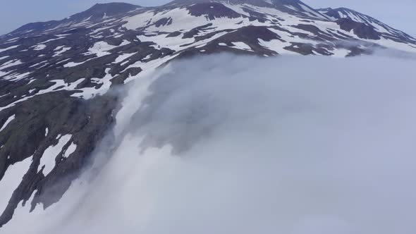 Aerial Footage of the Gorely Volcano Peaks Rising Above the Fog