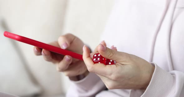 Red Dice and Smartphone in Female Hands