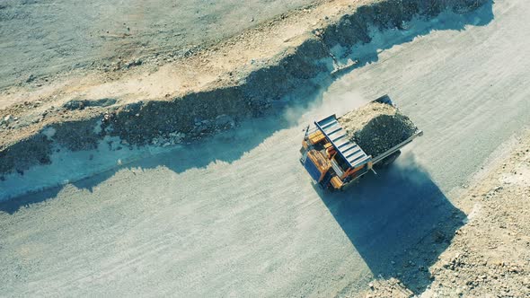 Top View of a Loaded Truck Riding Across the Open Pit