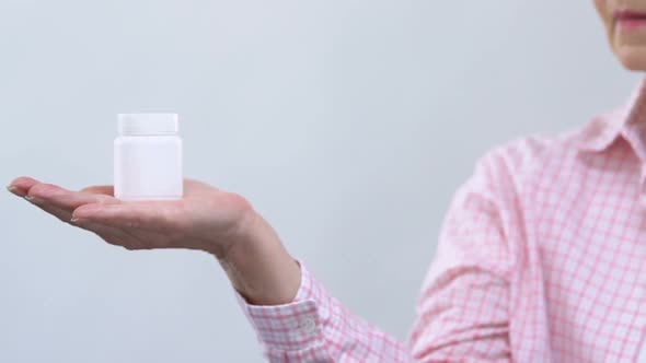 Sad Woman Looking at Pills Jar, Expensive or Ineffective Treatment, Side Effects