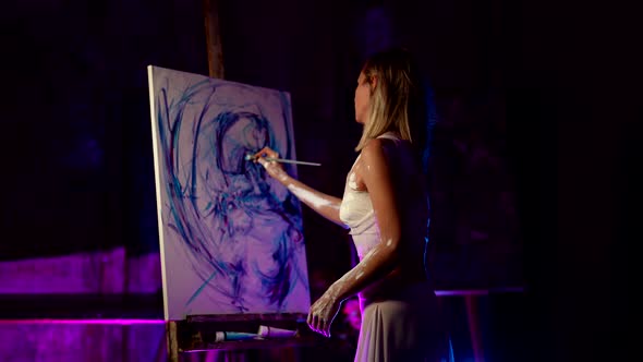 Inspired Young Woman is Drawing Scary Abstract Picture on Easel Painting Her Nightmare or Memory