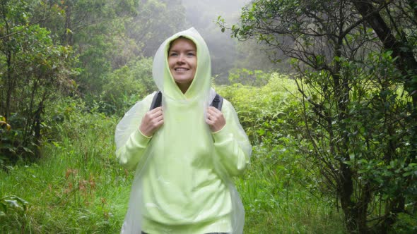Happy Hiker Childhood Concept in the Pouring Rainwet Season in Fern Rainforest