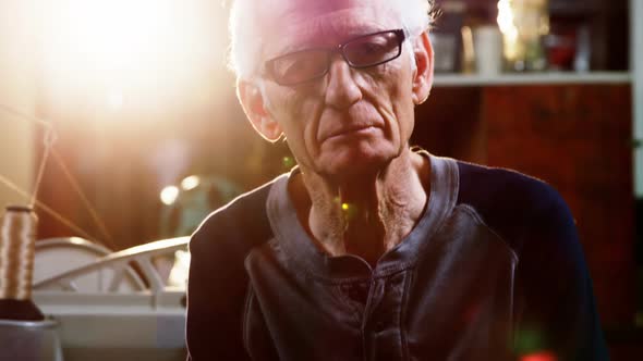 Portrait of shoemaker working in workshop