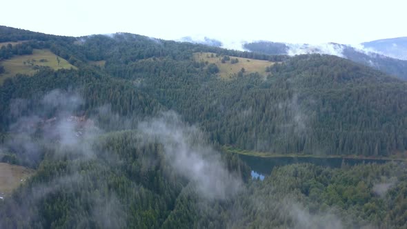 Majestic Aerial Drone Shot Rising through the Valley Fog and Mist to Reveal a River Cutting through