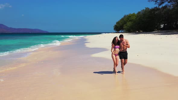 Fun Man and Woman on Romantic Honeymoon Have Fun on Beach on Summer White Sandy