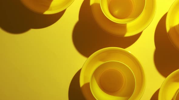 Yellow Plastic Bowls Are Placed in Layers for Background Texture.