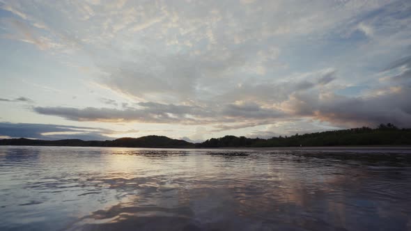 Water surface near coastline with hills and wonderful sky