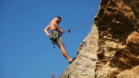 Climber Hanging On The Rock