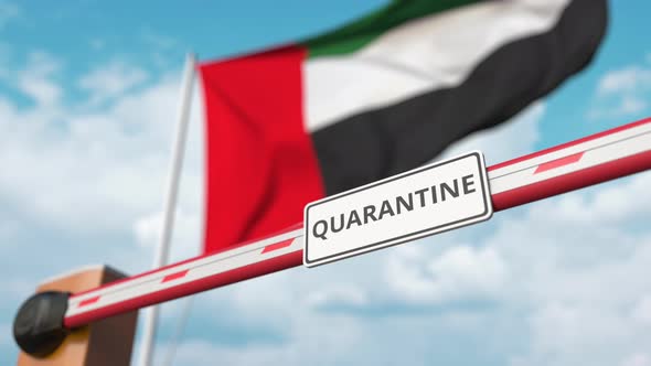 Opening Boom Barrier with QUARANTINE Sign Against the UAE Flag alt