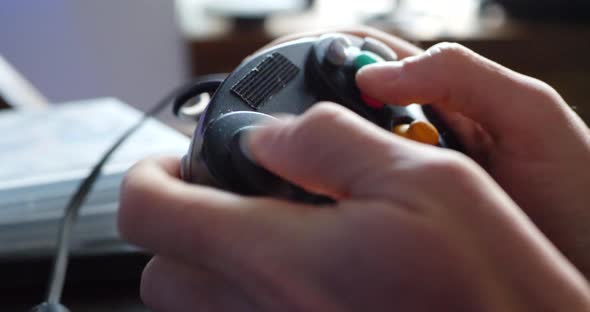Playing video games with a controller during an esports professional gaming tournament.
