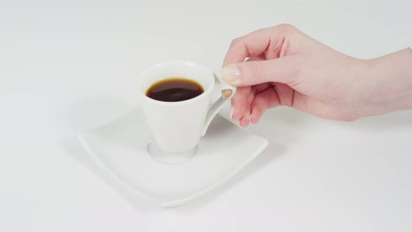 Putting a coffee and a cookie on a plate