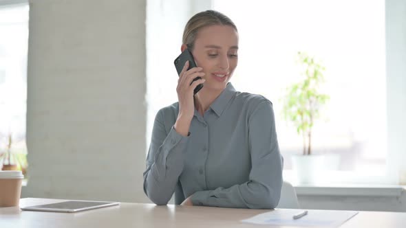 Woman Talking on Phone in Office