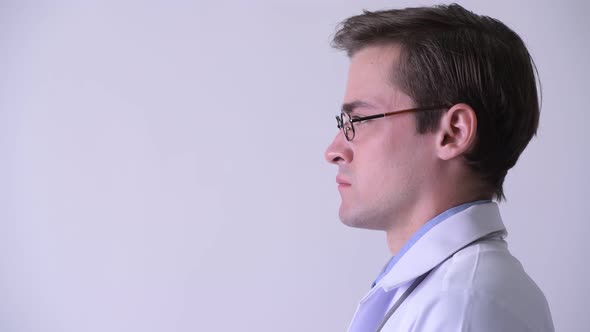 Profile View of Young Handsome Man Doctor Smiling