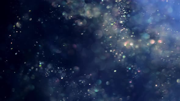 Blue Glitter Background Shot in Slow Motion. Underwater Particles Flying and Shining in Spotlight