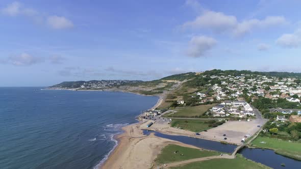 Aerial of Charmouth and the Jurassic coast tracking upward. revealing shot of the vast coastline loo