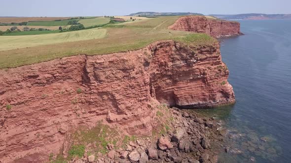 4K, Aerial view of beautiful red cliffs at Budleigh Salterton, Devon, UK