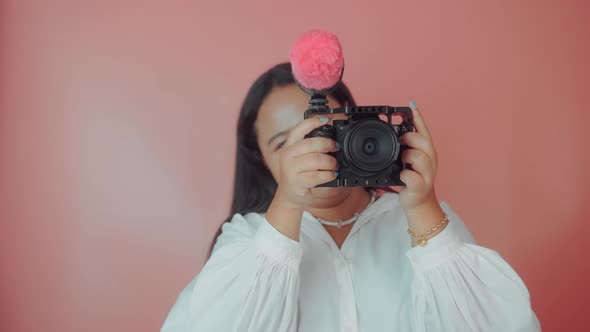 Portrait of a Young Beautiful Woman Using a Video Camera