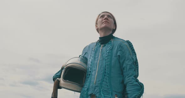 Female Astronaut Looking Towards Sky