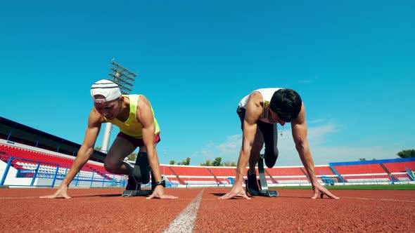 Men with Leg Substitutes Start Racing at the Stadium