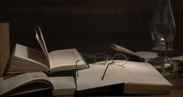 Table full of books and kerosene lamp