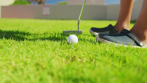 Close Up of the Golf Stick Hitting a Golf Ball