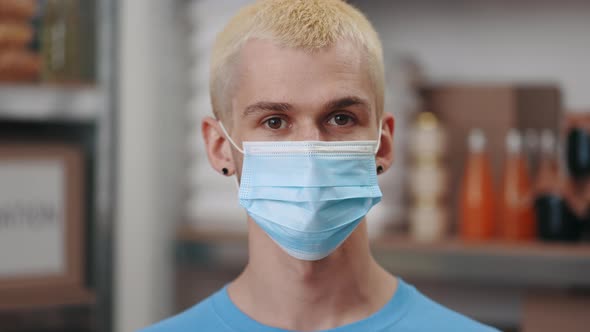 Portrait of Man in Face Mask Posing at Food Bank Warehouse