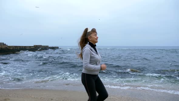 Mature Woman Is Running Along Sea Shore