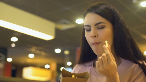 Pretty Female Eating Crispy French Fries Fast Food Restaurant, Unhealthy Snack