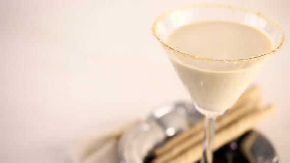 Holiday eggnog cocktail with dark rum and milk garnished with nutmeg.