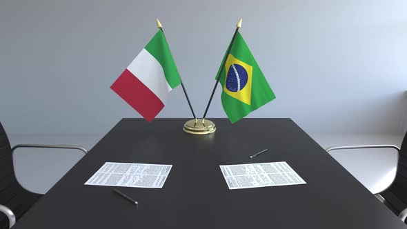 Flags of Italy and Brazil and Papers on the Table alt