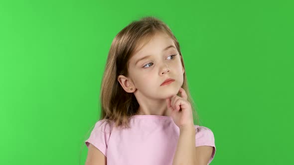 Baby Is Looking at the Side, She Is Thoughtful. Green Screen