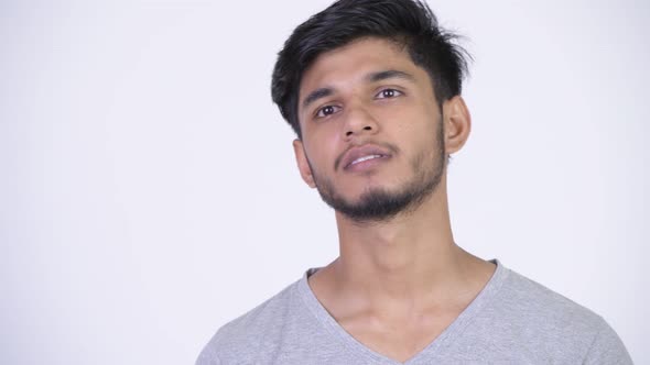 Young Happy Bearded Indian Man Thinking