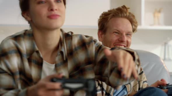 Playful Couple Enjoy Joysticks Game at Home Closeup