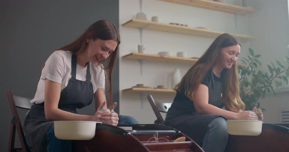 Two Young Woman in Pottery Studio Using Pottery Wheel Handmade Ceramics Creative