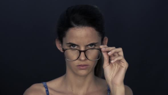 Woman adjusting glasses to improve vision