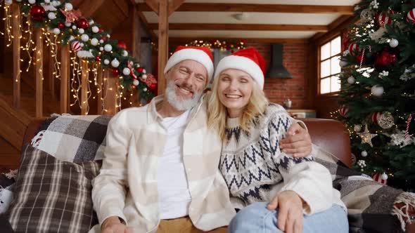 Happy Older Couple Greeting Family on Christmas Video Call Webcam View