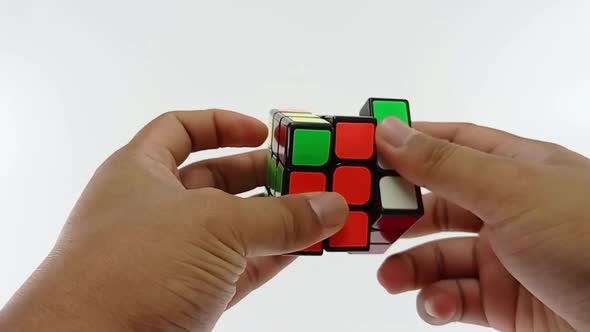 Men's Hands Solving Rubik's Cube Puzzle