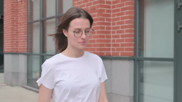 Close up of Young Woman Walking on Street, Side View