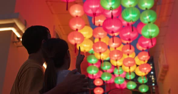 Couple look at the chinese lantern together at outdoor 