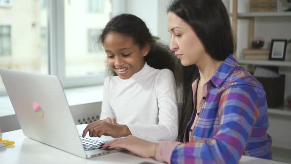 Medium Shot of Happy Black Girl at Home Talking with Aultd Teacher From Secondary School Helping Her